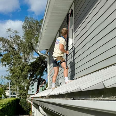 IMG_6893 Famously Clean team member cleaning a 2nd story window in Orlando