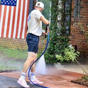 team.Sunglasses.1T4A8414 Pressure washing pavers at the entrance of a home in Orlando