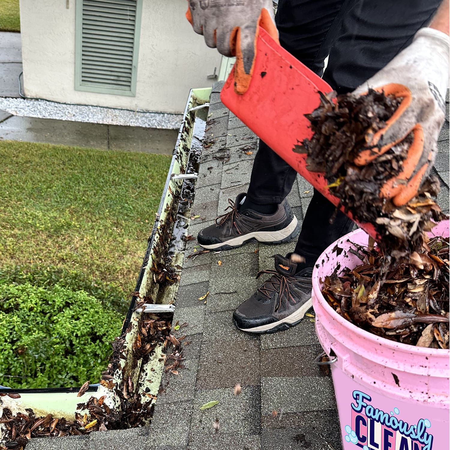 Famously Clean removing leaves from a gutter in Orlando