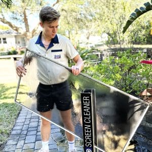 Famously Clean cleaning a window screen in Orlando - Lake Eola Heights